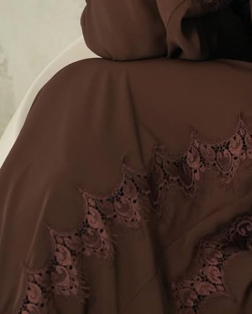 Close-up of scalloped lace on a chocolate brown abaya