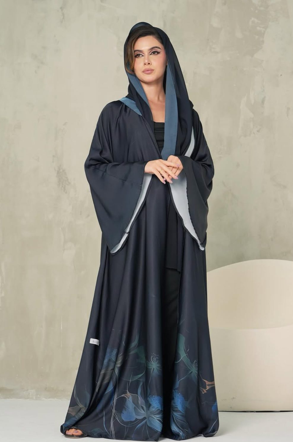 Navy abaya with a floral printed hem and a blue-lined shayla