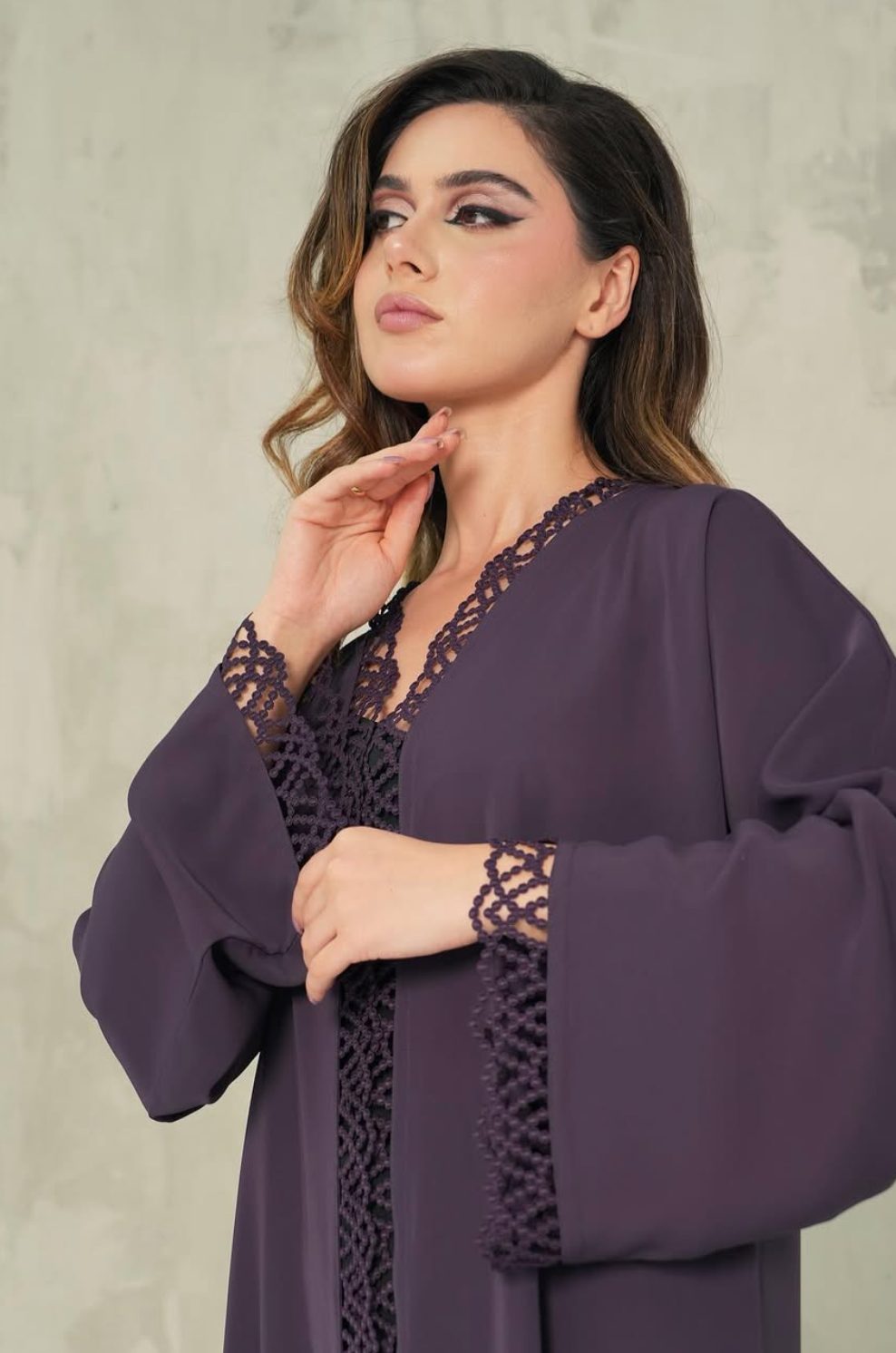Plum abaya with lattice lace trim along the opening and cuffs